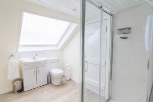 a bathroom with a shower and a toilet and a sink at Dalnaglar Castle Estate in Glenshee +38 photos