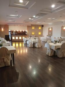 a dining room with white tables and white chairs at Hotel TiM in Cekanowo
