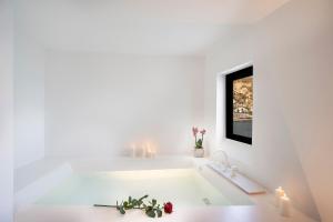 a bath room with a white bath tub next to a window at Miramare Sea Resort & Spa in Ischia