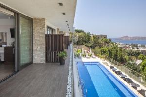 a view from the balcony of a house with a swimming pool at Spektr Boutique Hotel Yalikavak in Yalıkavak