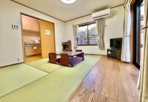 a living room with a table and a tv at Myabi -Ashinoko - Vacation STAY 72020v in Sekishoato