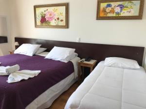 Cama ou camas em um quarto em Pousada Bosque das Araucárias