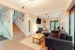 a living room with a couch and a staircase at Selters Guesthouse in Lueta