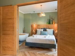 a bedroom with a bed and a bath tub and a tub at Nature and Haven of Peace Apartment in Paris