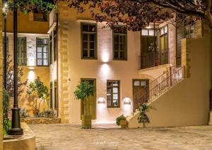 a building with a door and a courtyard with plants at Neratze Hammam Suites in Rethymno Town