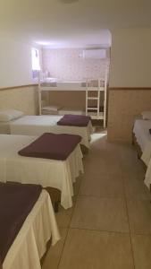a room with four beds and a ladder in it at Pousada São Judas Tadeu in Cachoeira Paulista