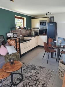 a kitchen and living room with a couch and a table at Ferienwohnung MaarBurg in Ulmen