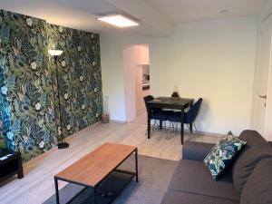 a living room with a couch and a table at Studio de Spa in Spa
