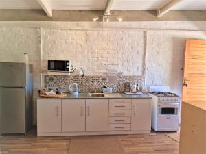 a kitchen with white cabinets and a white stove at GreenHouse Accommodation in Tulbagh