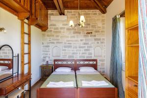 A bed or beds in a room at Kalimera villas