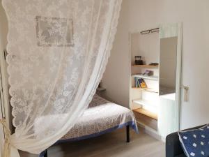 a bedroom with a bed with a curtain at CA del CARMINE in Florence