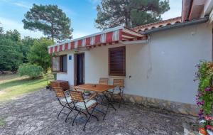 a table and chairs in front of a house at St. Bečić in Poreč