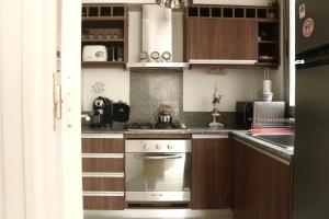 a kitchen with a stove and a sink at Departamento Terra IV in Mar del Plata