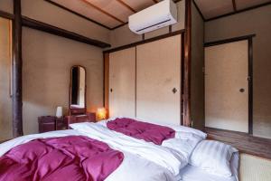 Postel nebo postele na pokoji v ubytování お宿梅夜Guesthouse Umeya