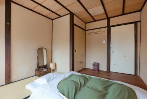 Postel nebo postele na pokoji v ubytování お宿梅夜Guesthouse Umeya