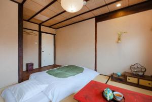 Postel nebo postele na pokoji v ubytování お宿梅夜Guesthouse Umeya