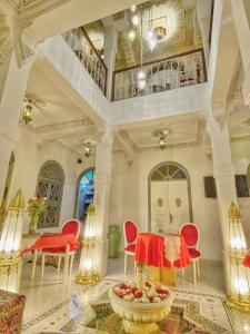 a living room with a table and chairs and a ceiling at Riad Kech Soul Boutique & Spa in Marrakesh