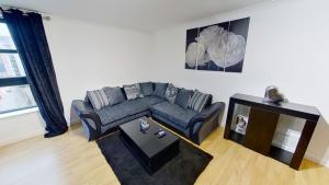 a living room with a couch and a table at OrangeApartments Riverside Drive,5 Minutes from City Centre in Aberdeen