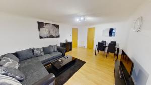 a living room with a couch and a table at OrangeApartments Riverside Drive,5 Minutes from City Centre in Aberdeen
