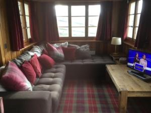 a living room with a couch and a laptop on a table at Chalet Chouc'le in Vercorin