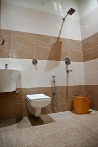 a bathroom with a toilet and a shower at KOZZY B&B in Amritsar
