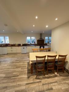 a kitchen with a table and chairs and a kitchen with a counter at Old Irish farmhouse in Dingle