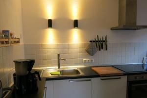 a kitchen with a sink and a light over a counter at Ferienwohnung Arenz in Schweinfurt