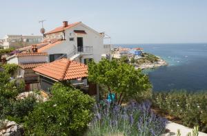 a house with a view of the ocean at Apartments Lucija in Ražanj