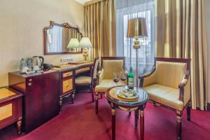 a hotel room with a desk and chairs and a table at Hotel Lime Krasnoselskaya in Moscow