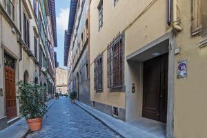 an alley in an old city with buildings at The Charm of Santa Croce in Florence
