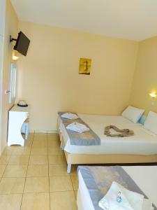 A bed or beds in a room at Celeste Golden Beach