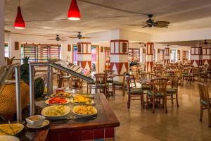 a restaurant with plates of food on a table at Royal Decameron Club Caribbean Resort - All Inclusive in Runaway Bay