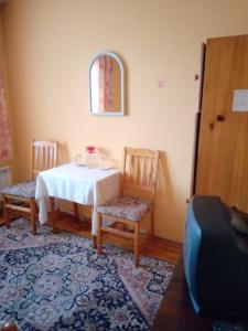 a dining room with a table and two chairs at Hotel Lavega in Kyustendil