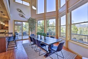 a dining room with a table and chairs and windows at Silverthorne Cabin with Deck, Grill and Balcony! in Silverthorne