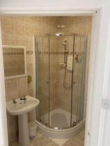 a bathroom with a shower and a sink at Queensberry arms hotel in Kirkconnel