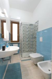 a bathroom with a sink and a toilet and a shower at Il Cavaluccio Marino House in Salerno