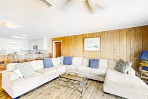 a living room with a white couch and blue pillows at Hakuna Matata in Gulf Shores