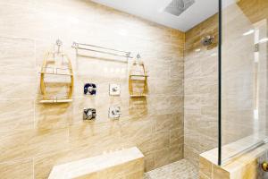 a bathroom with a shower with a glass door at Hakuna Matata in Gulf Shores +25 photos