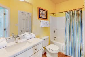 a bathroom with a sink and a toilet and a shower at Plum Cute by Meyer Vacation Rentals in Gulf Shores +9 photos