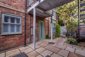 a brick house with a window and a patio at Minster's Reach York close to York Minster in York