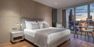 a bedroom with a large bed with a view of a city at Melas Hotel Istanbul in Istanbul