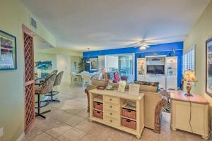 a living room with a couch and a table at Coastal Penthouse Steps to New Smyrna Beach! in New Smyrna Beach