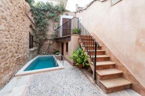 a house with a swimming pool next to a stairs at Holiday Home Ca Na Blan ca in Alcudia