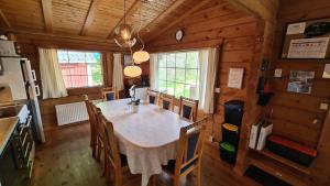 a dining room with a table and chairs in a cabin at Ferienhaus Kappeled in Kappeled +24 photos