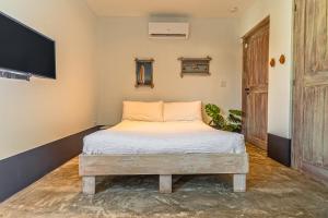 a bed in a room with a tv on the wall at Luxurious OCEAN VIEW Getaway in Noord +48 photos