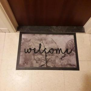 a sign on a tile floor with the word welcome at Gaviota in Westende