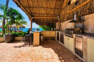 an outdoor kitchen with a view of the ocean at Private Beach Ocean Front Boat Dock Tiki Bar in Savaneta