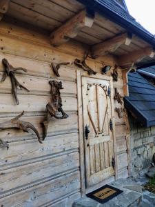 an entrance to a wooden building with a door at Marynka in Zakopane