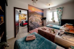 a hotel room with two beds and a mirror at Apartamenty Stara Mleczarnia in Ustrzyki Dolne