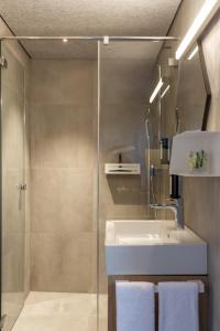 a bathroom with a sink and a shower at The Lab Capsule in Thun